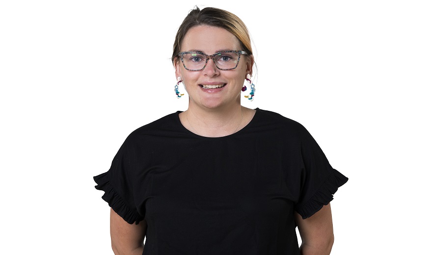 Female student smiles for the camera in photography studio.